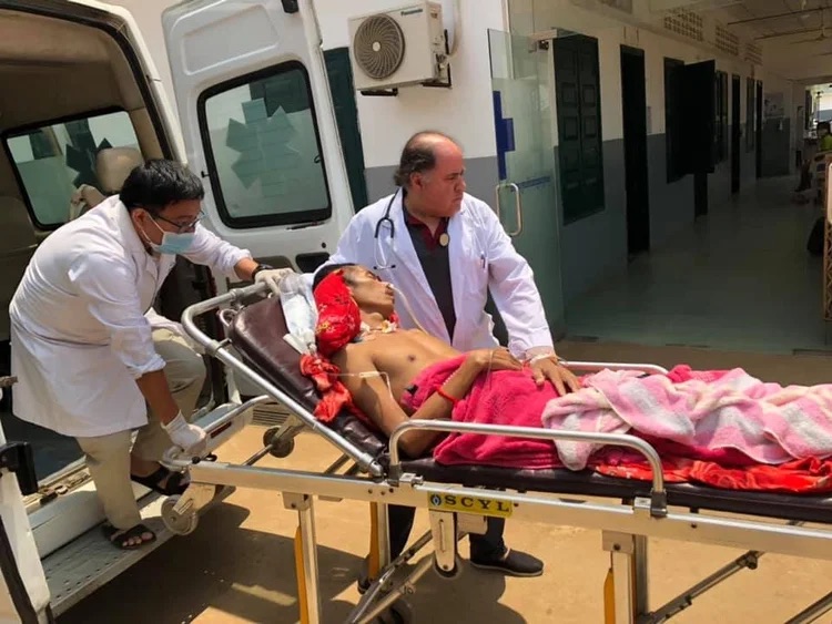 A clinician tending to Sok Chorn during the ambulance transfer.