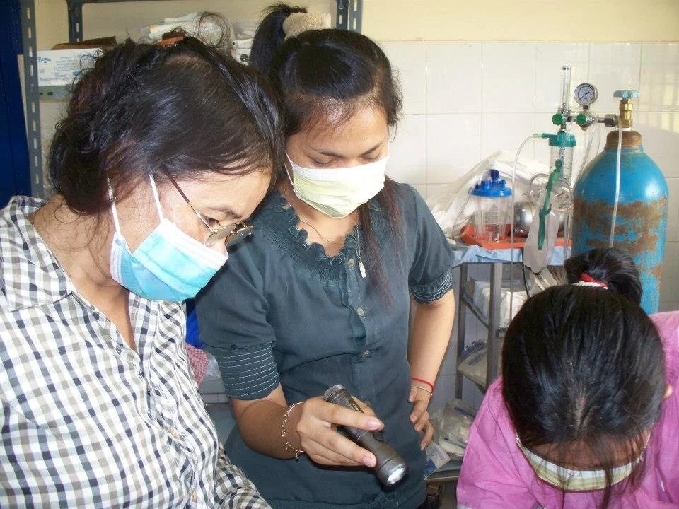 Two patients standing together at the clinic.